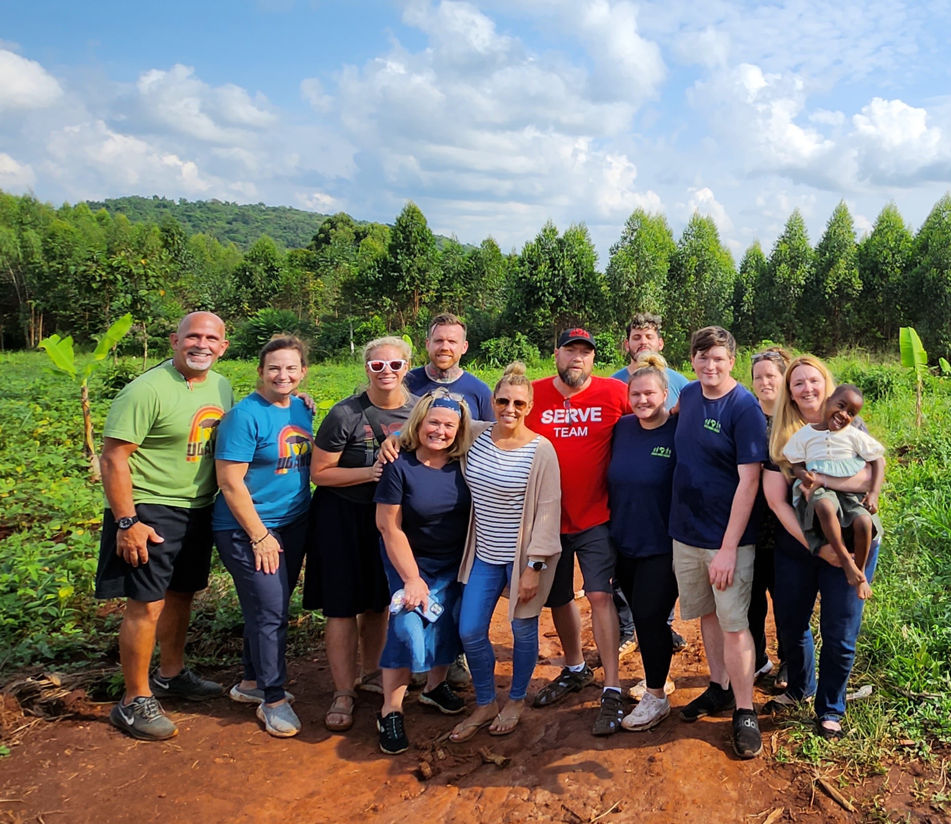 Mission trip members praying together during a gathering in Uganda.
