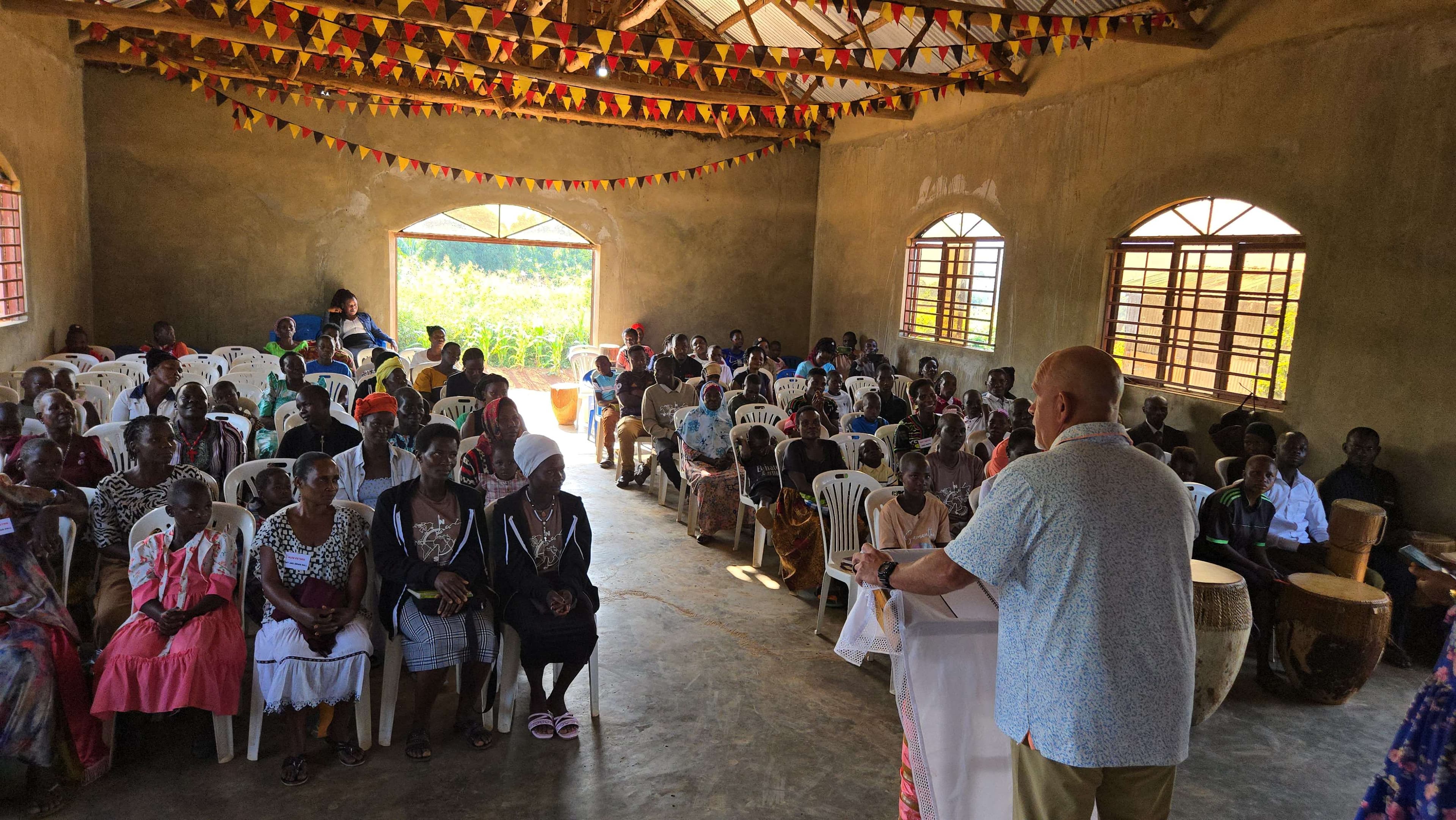 A church gathering in Uganda with AFR team members and community families.