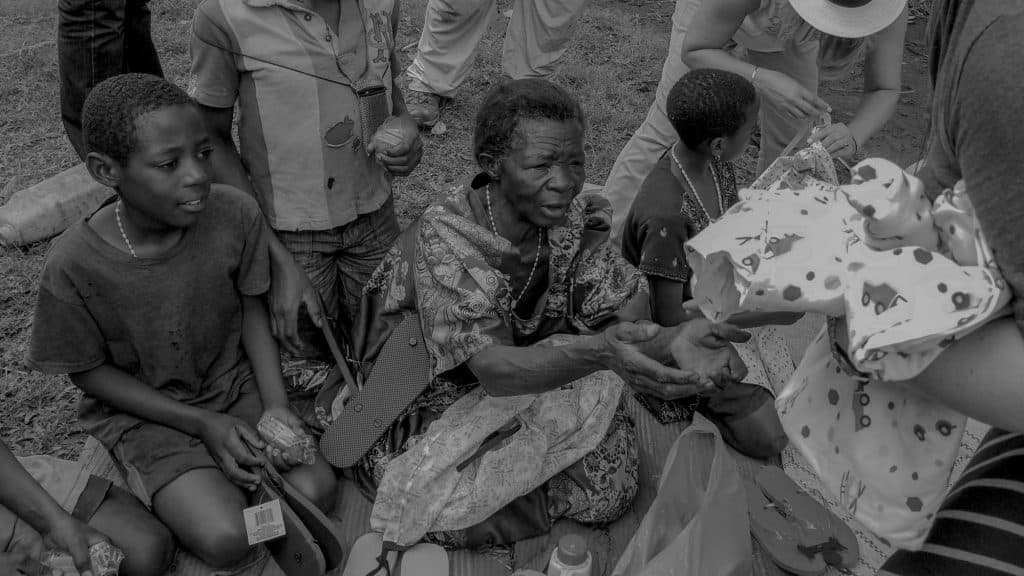 A mission team sharing gifts with community members in Uganda.