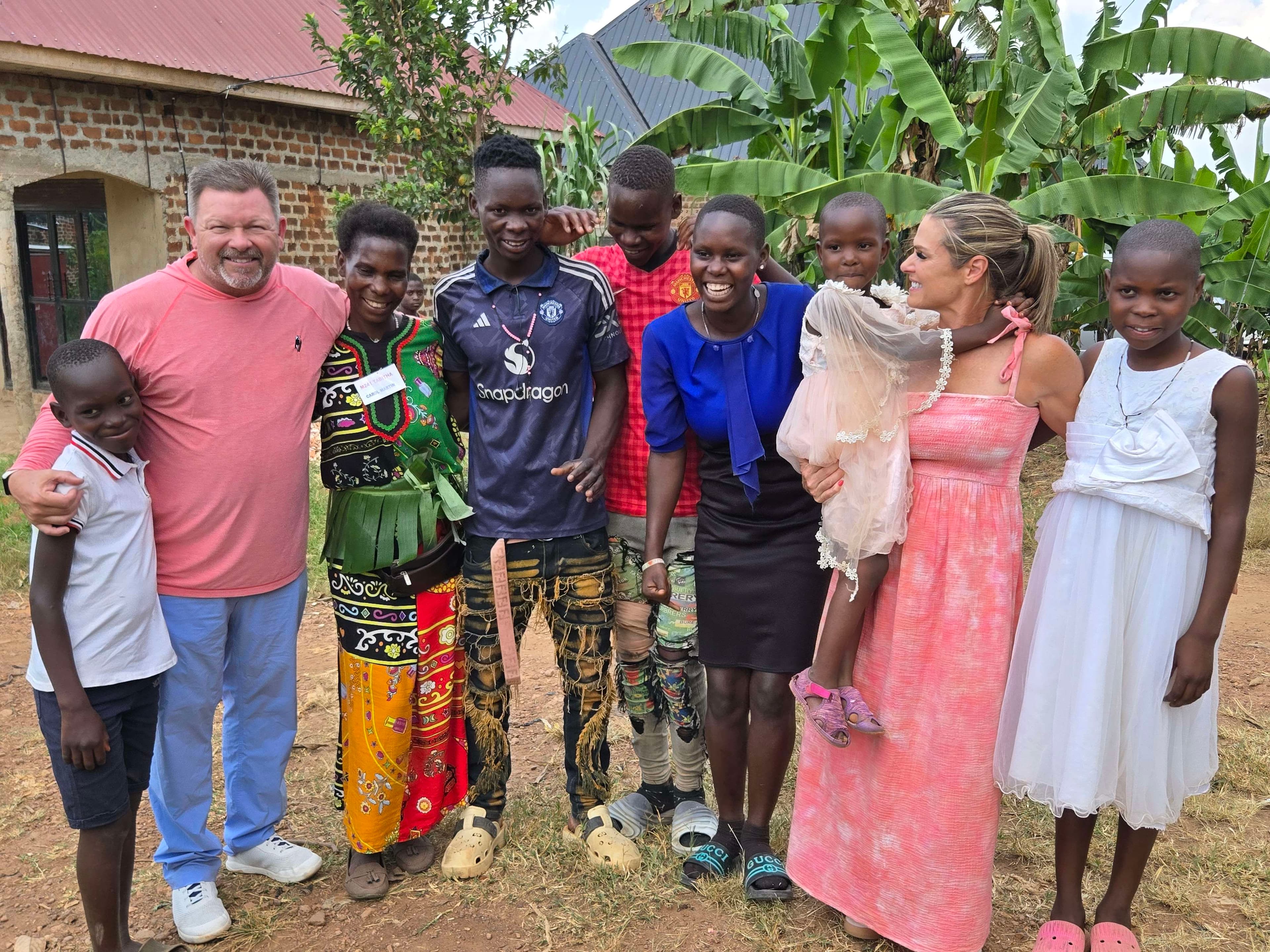 Africa Family Rescue sponsors standing with a family in Uganda.