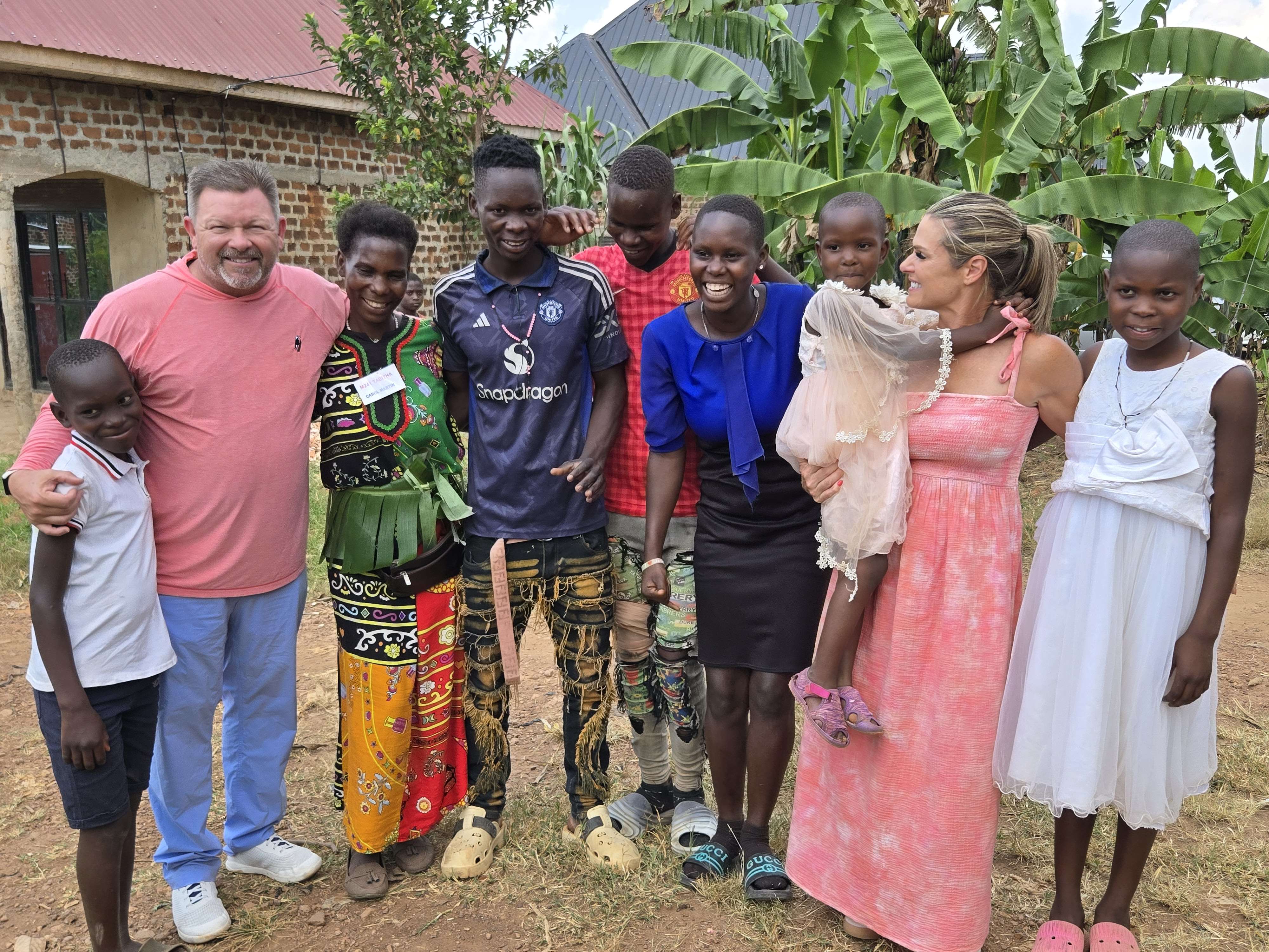 Africa Family Rescue sponsors standing with a family after long-term sponsorship support.